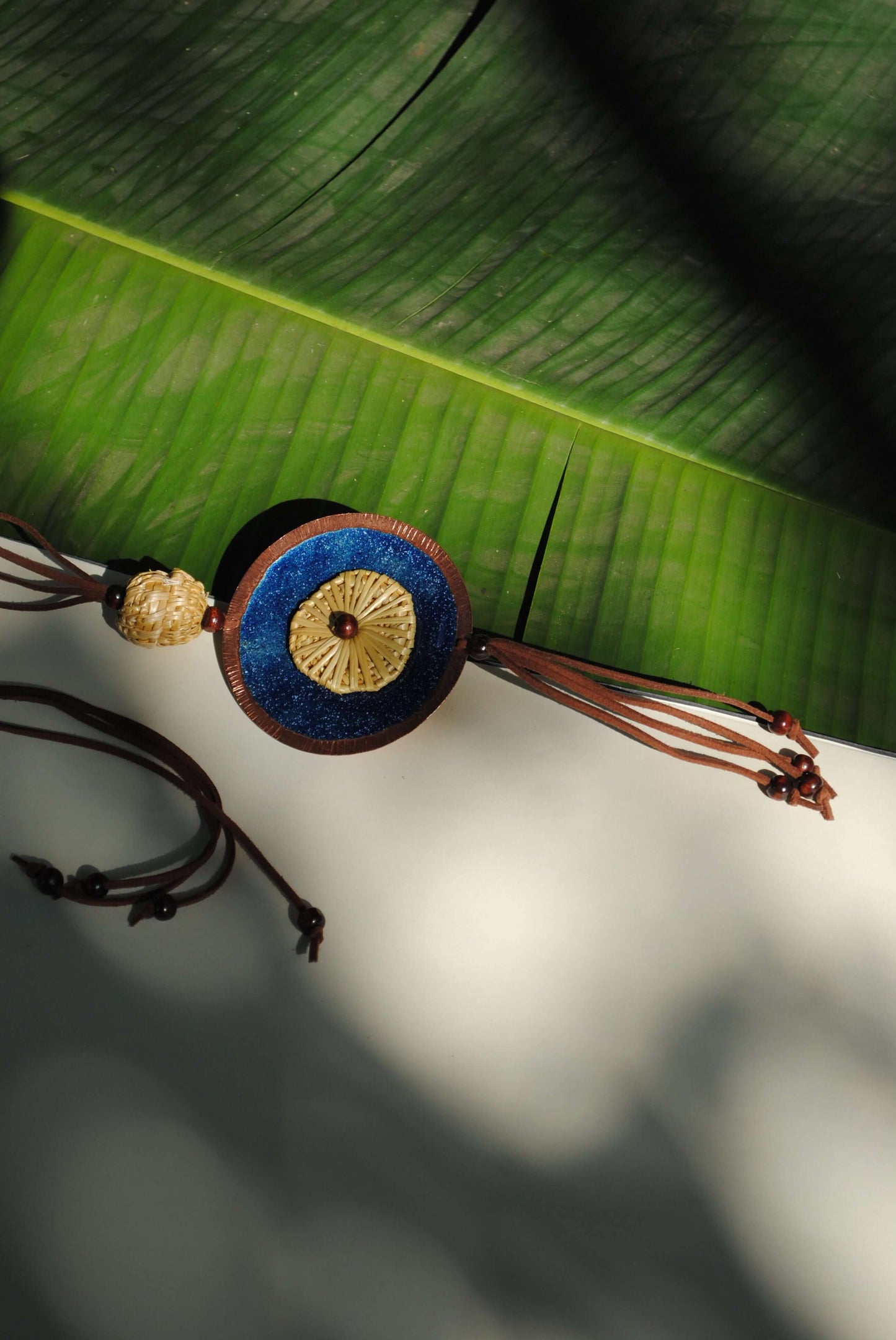 Truna natural fibre golden grass and copper enamel handcrafted jewelry from Odisha, Vaati blue pendant
