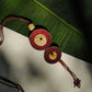 Truna natural fibre golden grass and copper enamel handcrafted jewelry from Odisha, Vaati red enamel pendant