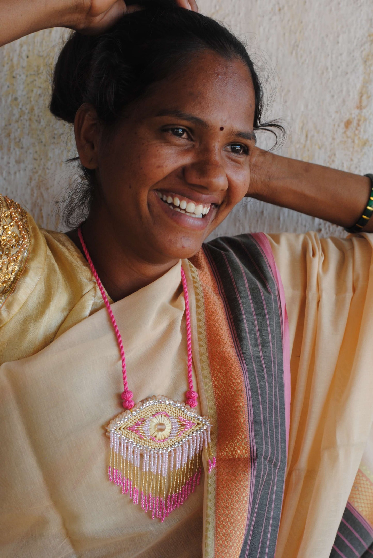Truna natural fibre golden grass and zardosi handcrafted jewelry from Odisha, nazar pink pendant