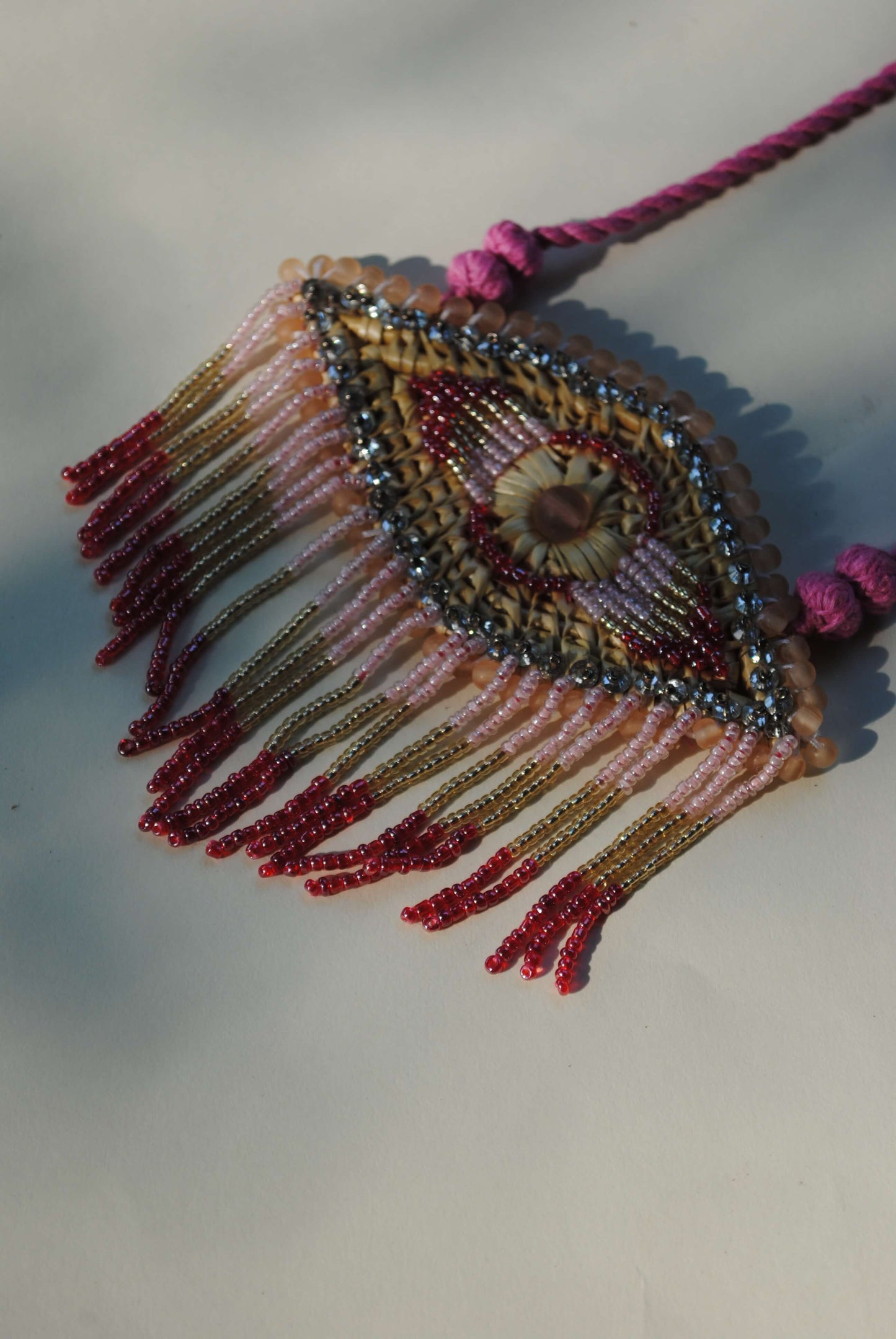 Truna natural fibre golden grass and zardosi handcrafted jewelry from Odisha, nazar pink pendant
